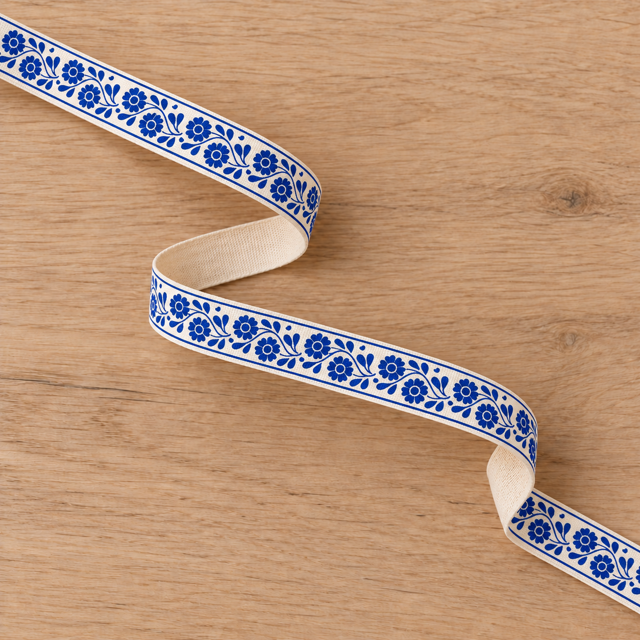 Blue floral ribbon on oak table-6.png
