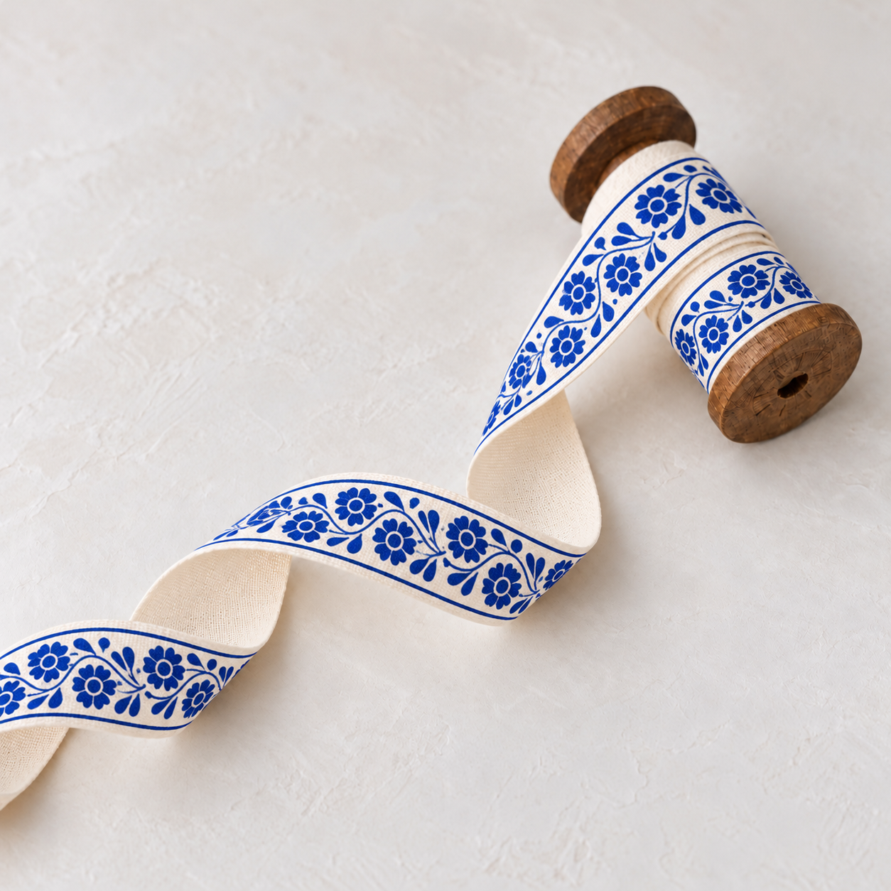 Cobalt floral ribbon on wooden bobbin-1.png