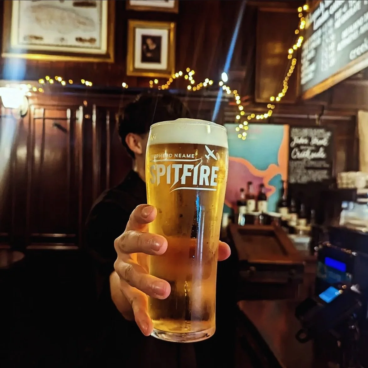 Shelf | fulfilment for drinks brands - Handing over a pint of Spitfire Lager from Shepherd Neame