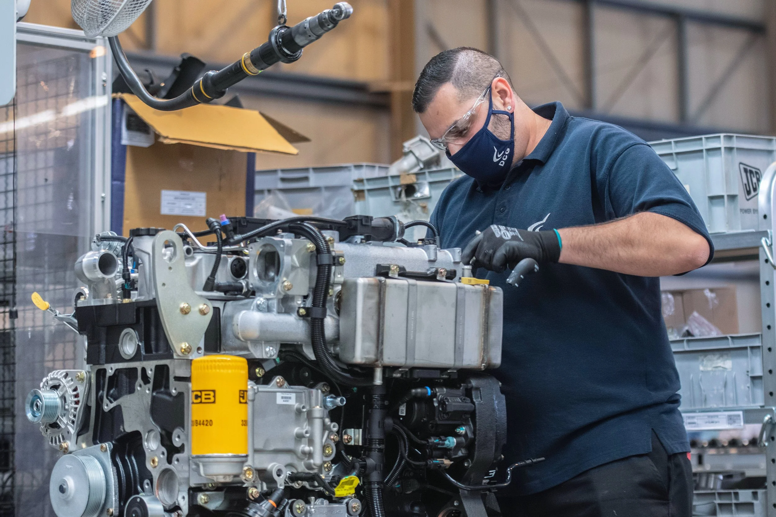 Manufacturing team building JCB machinery at UK production facility