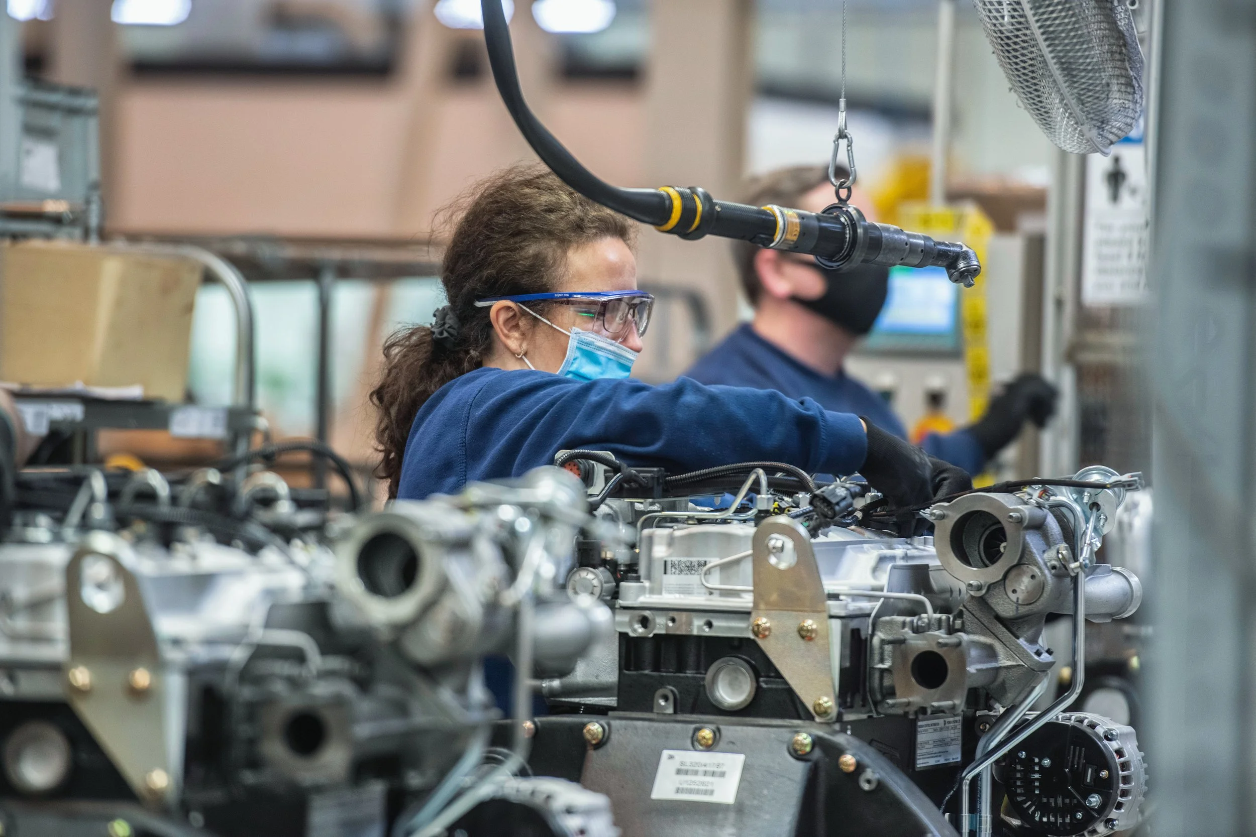 JCB factory workers fitting parts to construction equipment