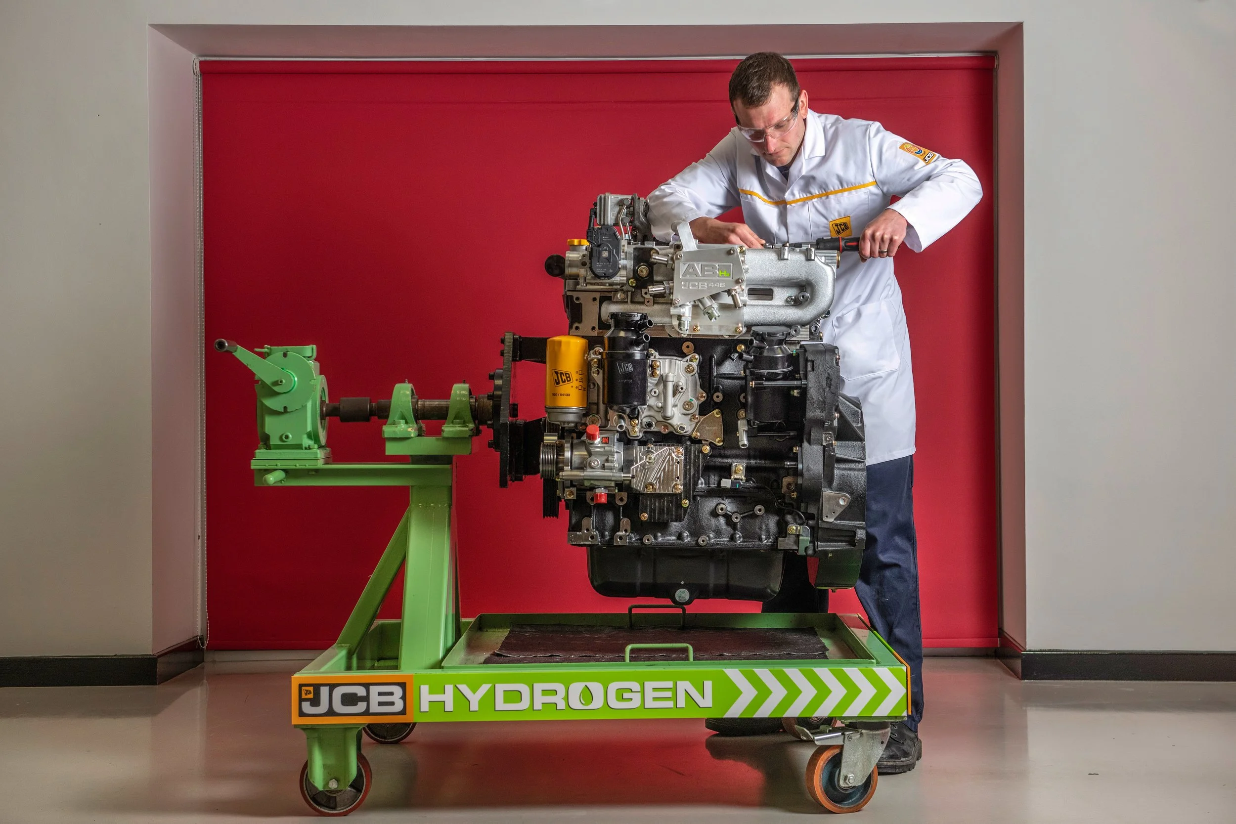 JCB engineers working on hydrogen-powered construction equipment in factory