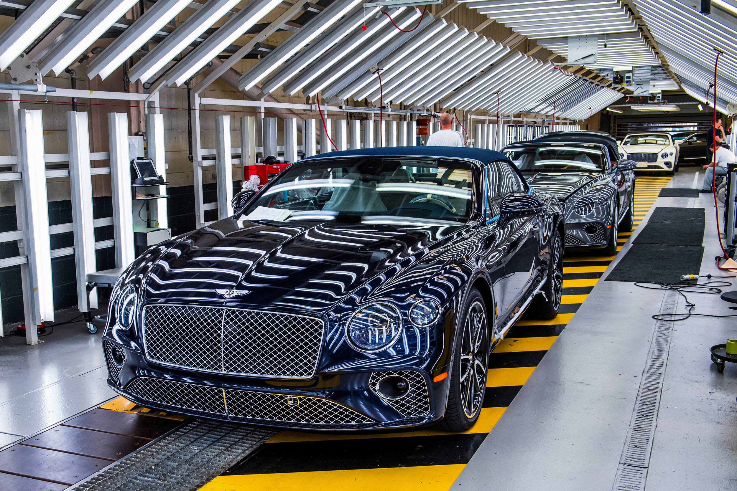 Automotive workers building Bentley vehicles in UK manufacturing facility