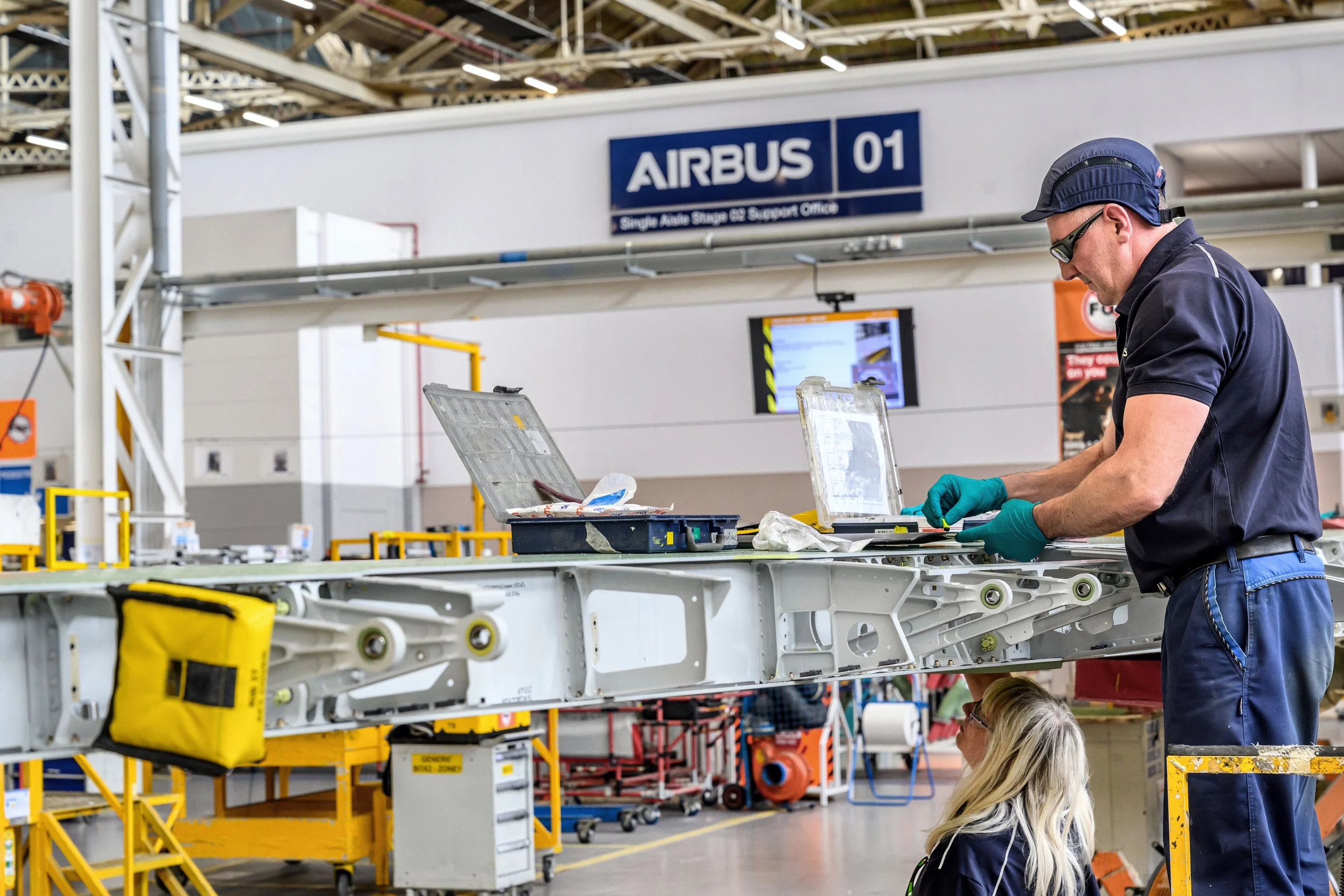 Airbus factory workers assembling aircraft components on production line