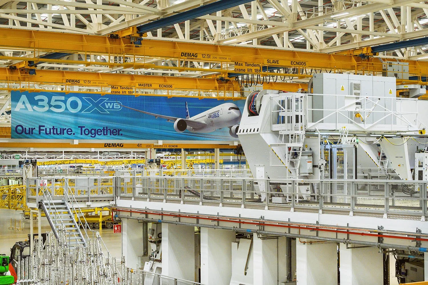 Airbus factory floor with workers and partially assembled aircraft