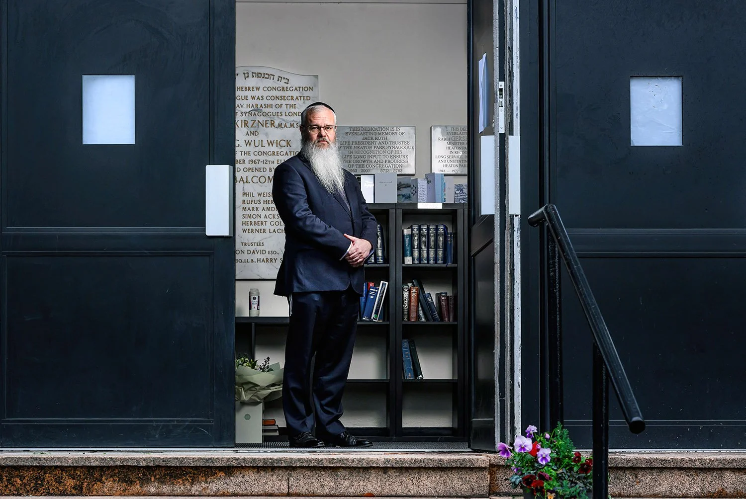 Reflective portrait of Rabbi Daniel Walker in synagogue setting