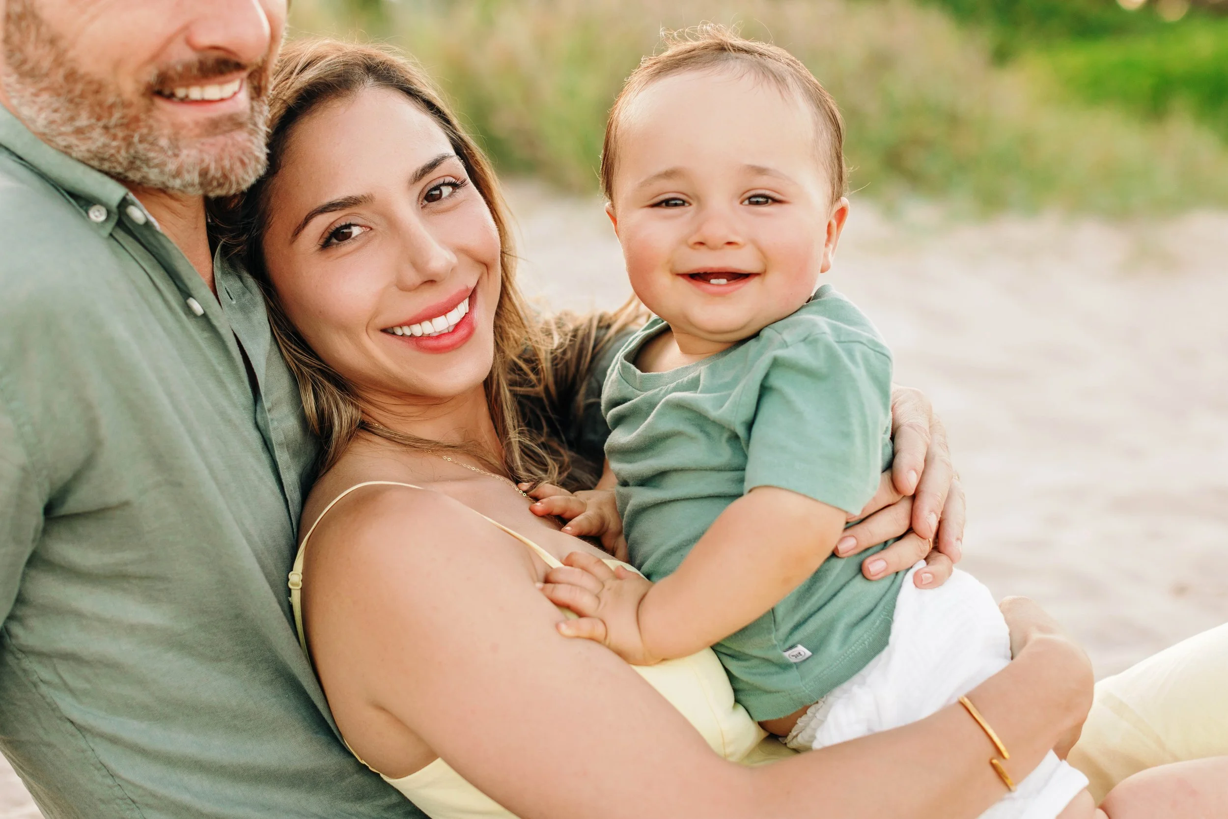 Mother holding her baby during a natural beach portrait session in Pompano Beach