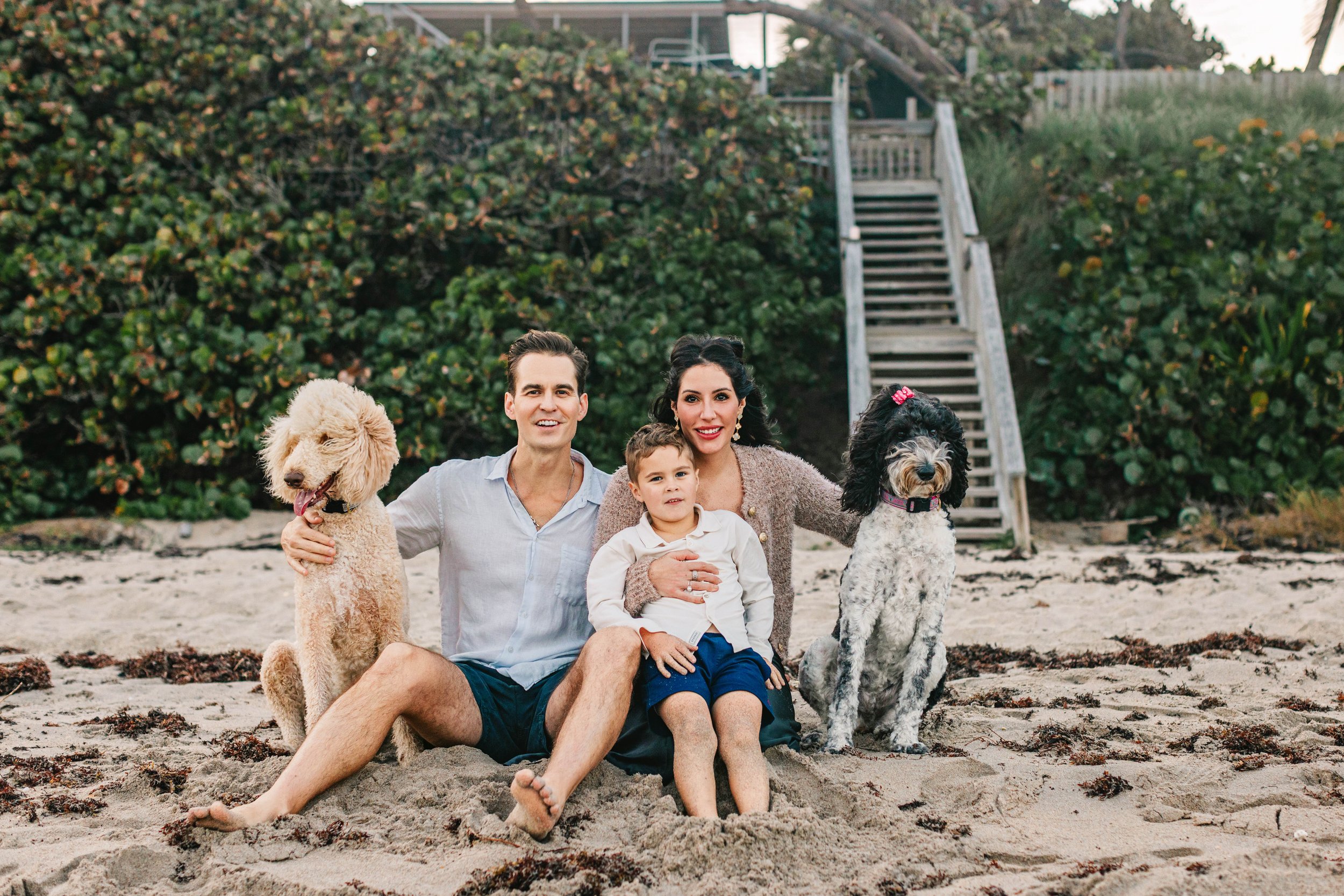 Family sitting together during a beach photography session in Delray Beach