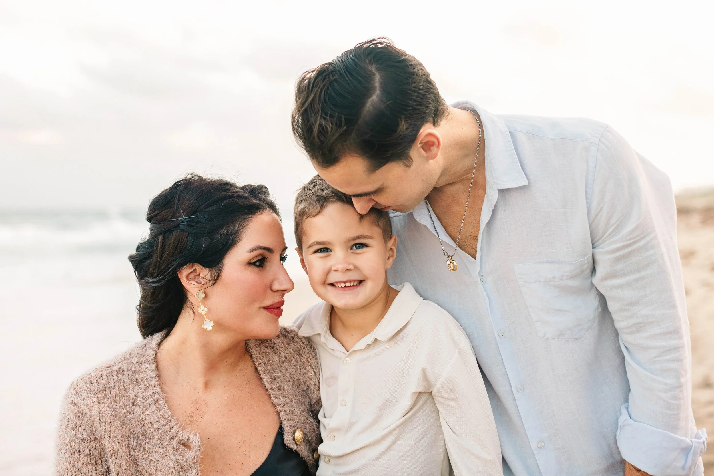 Parents with their son at a family beach photography session