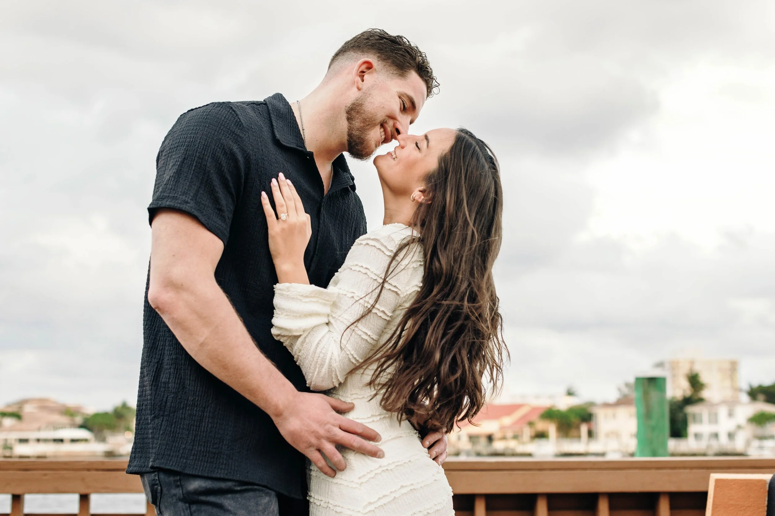 Couple celebrating their engagement during a natural, candid engagement photography session in Delray Beach, Florida,