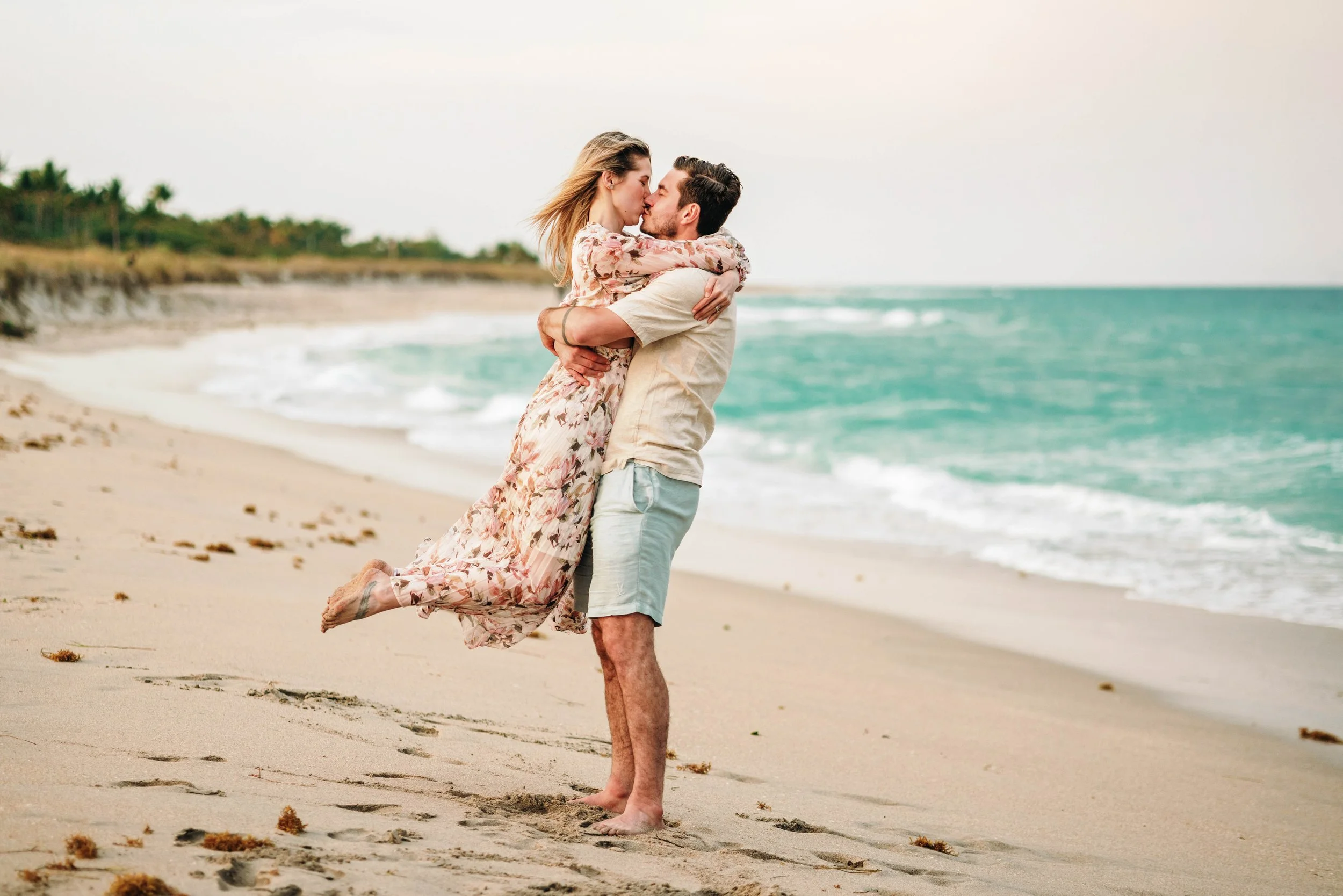 A couple is hugging at their beach photography session in Delray Beach