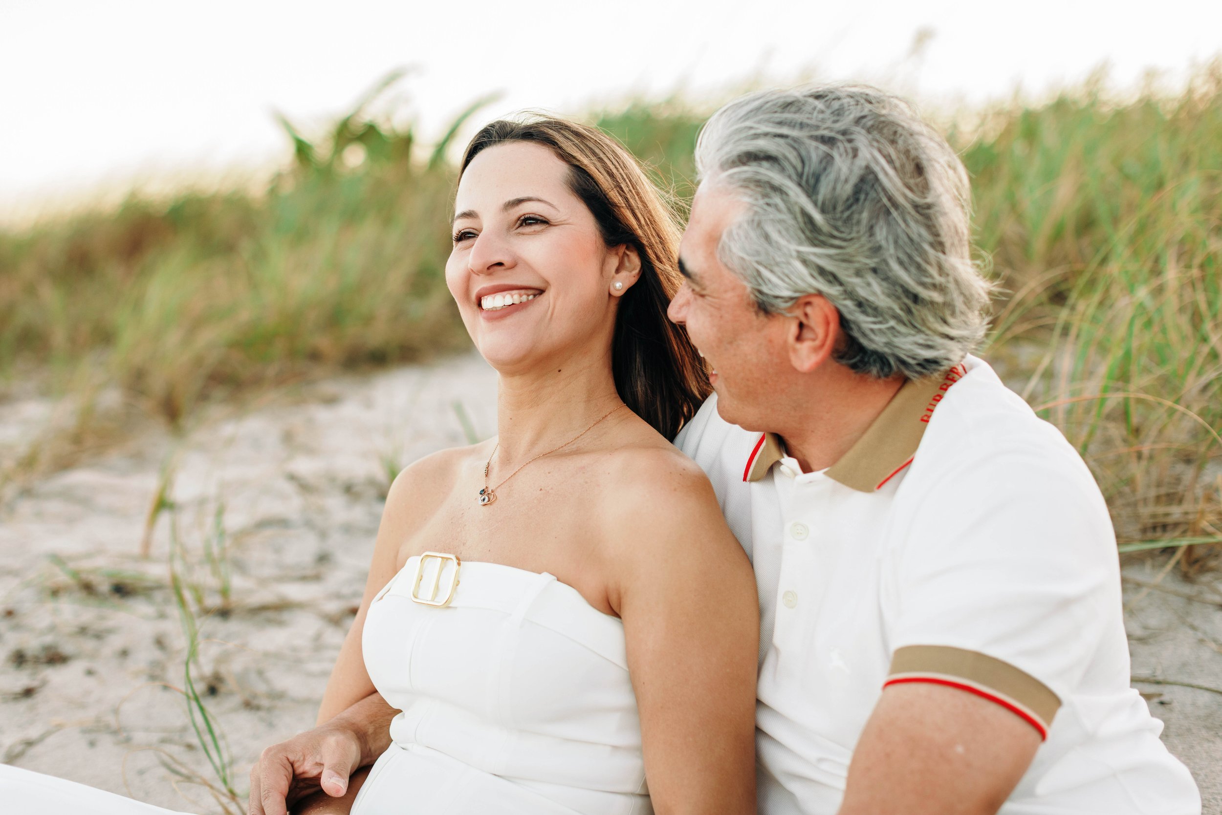Parents enjoying their family beach photography session in Delray Beach.