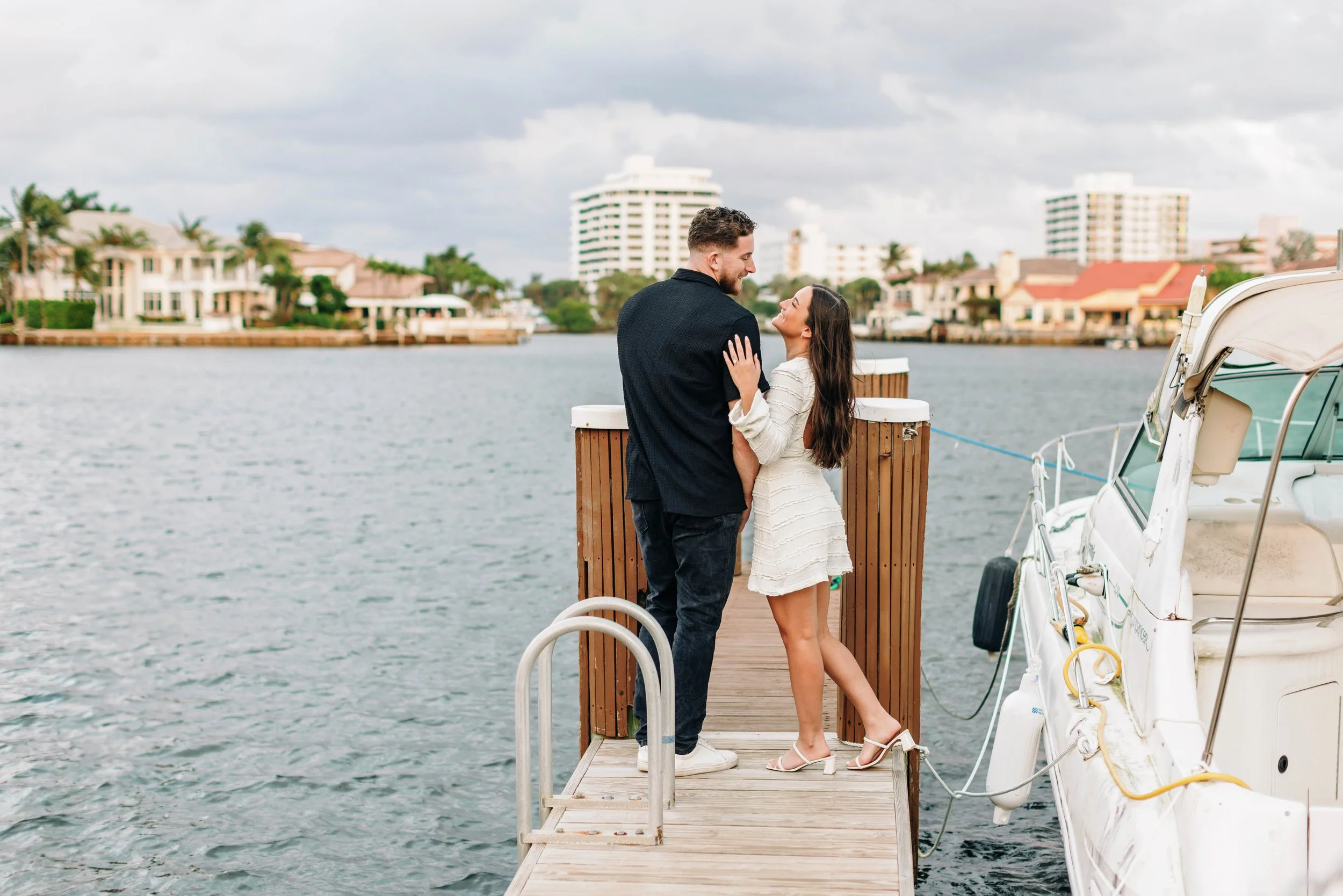 Engaged couple posing together during a surprise engagement photo session in Delray Beach, Florida, captured by a lifestyle engagement photographer.