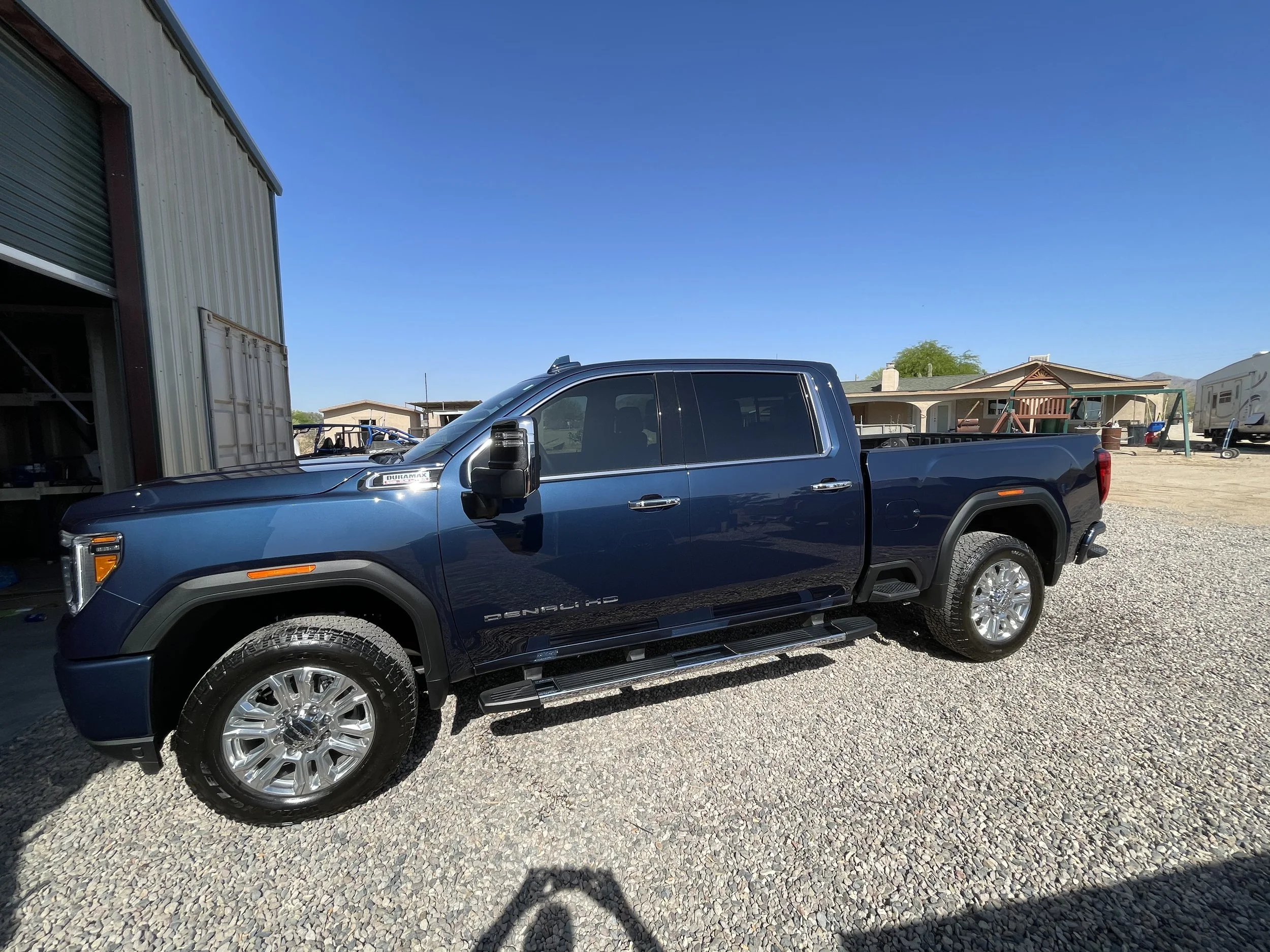 Blue GMC 2500 Denali truck shining in the sun after a maintenance detail in Buckeye, AZ