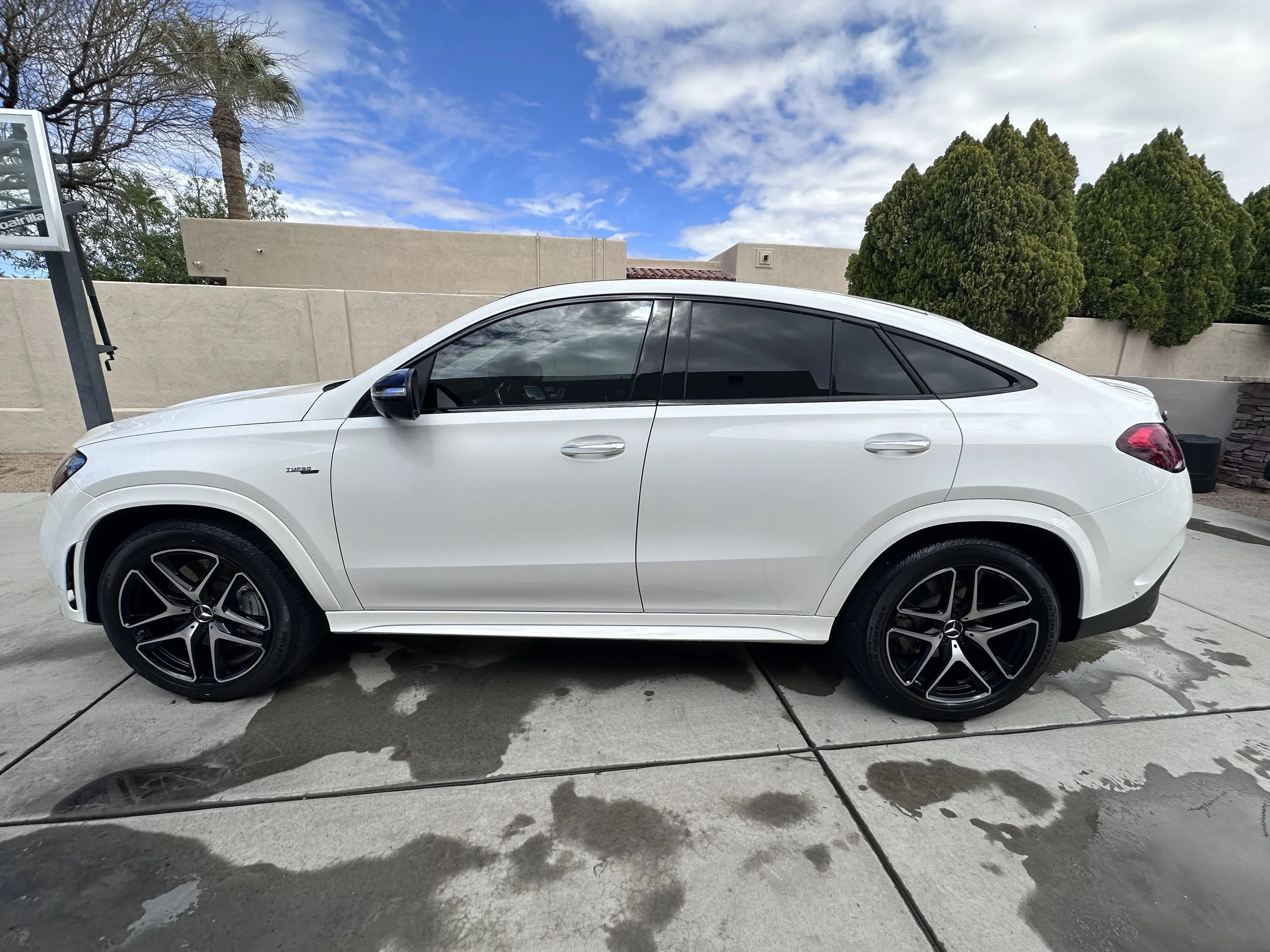 Mercedes crossover reflecting the clouds on the driveway after a complete detail for maintenance plan in Litchfield Park, AZ