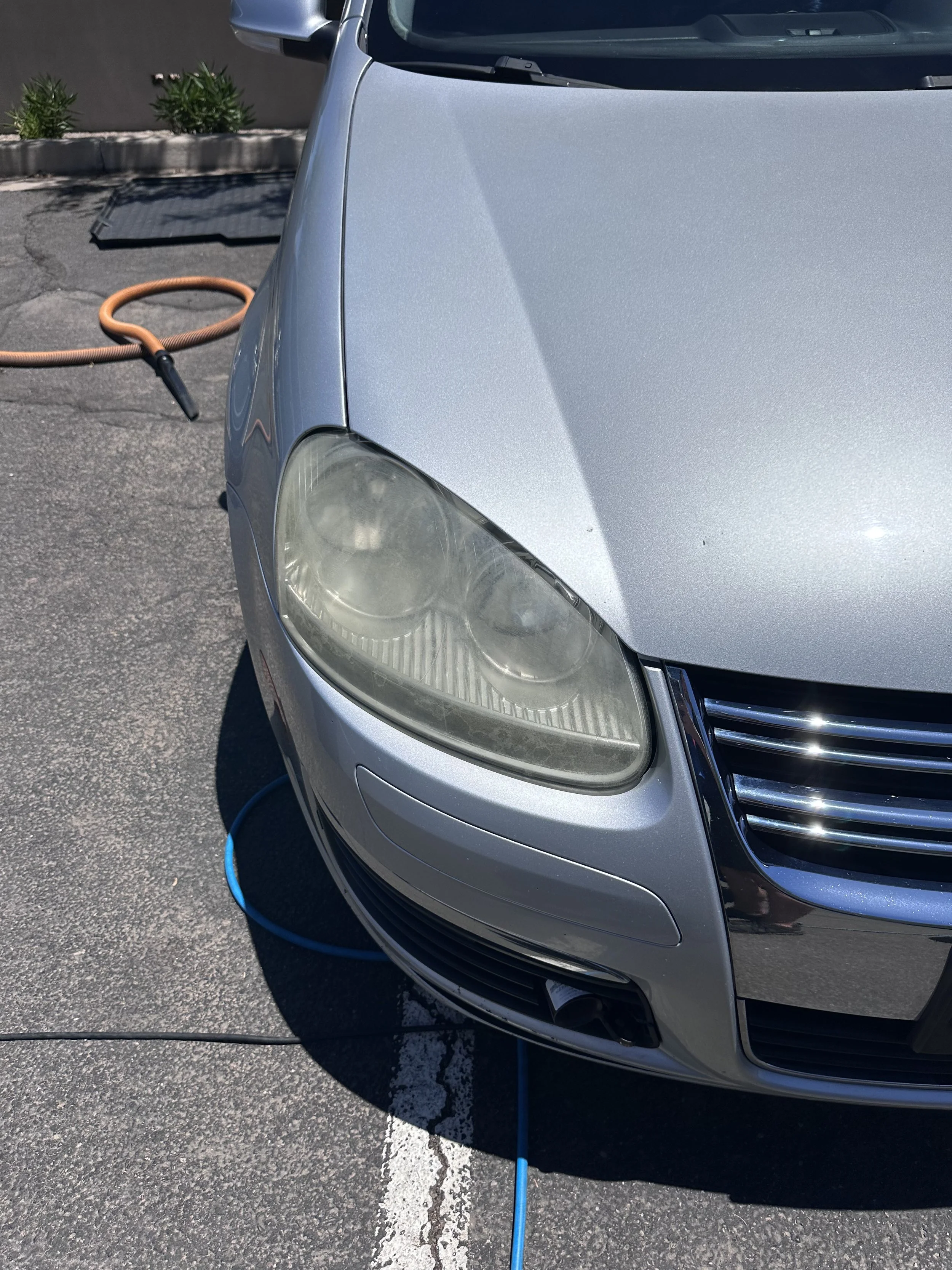 VW Jetta before headlight restoration service in North Phoenix, AZ.