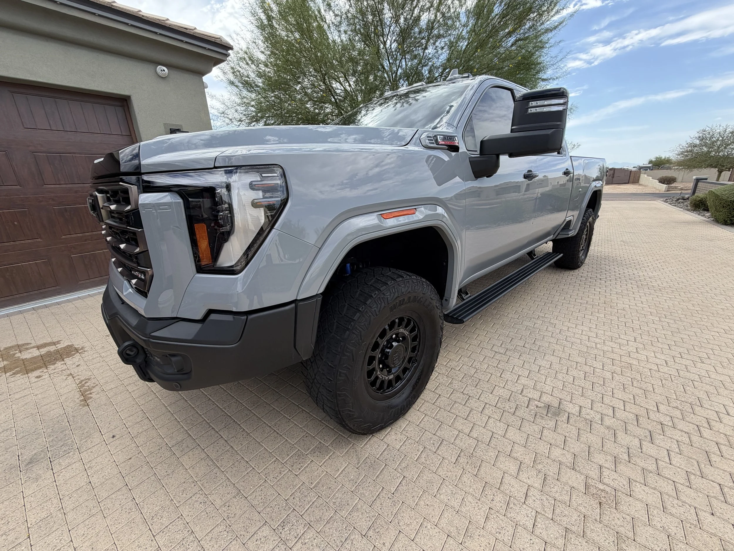 GMC Sierra 2500 AT4 reflecting the clouds after a maintenance detail in Peoria, AZ
