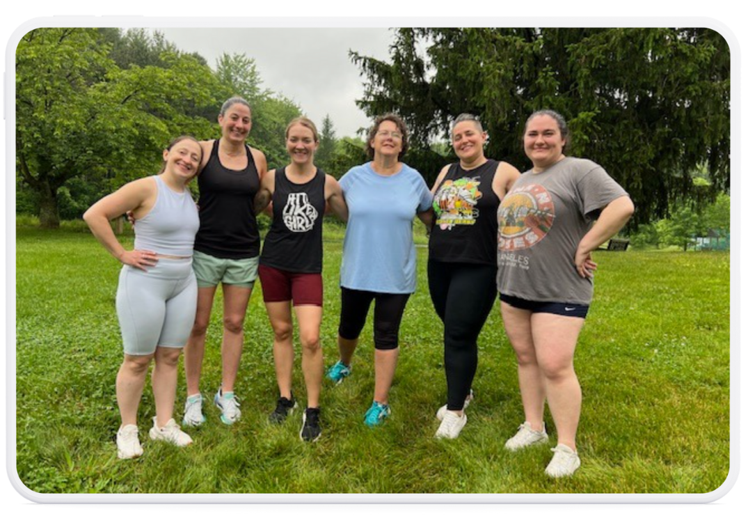 Women outside in their workout clothes after a strength training session at a Mostly Well wellness event