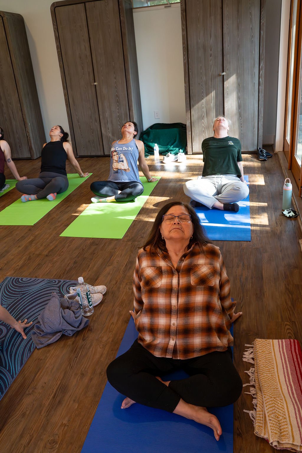 Retreat attendees seated on mats during a guided meditation