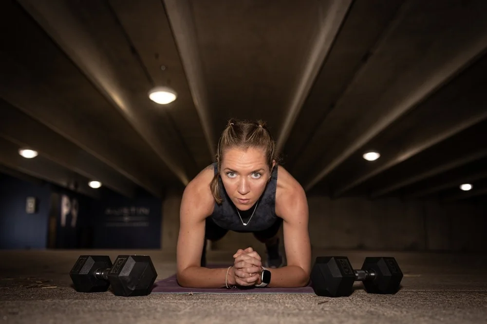 Coach Lisa Wade of Mostly Well holding a plank position