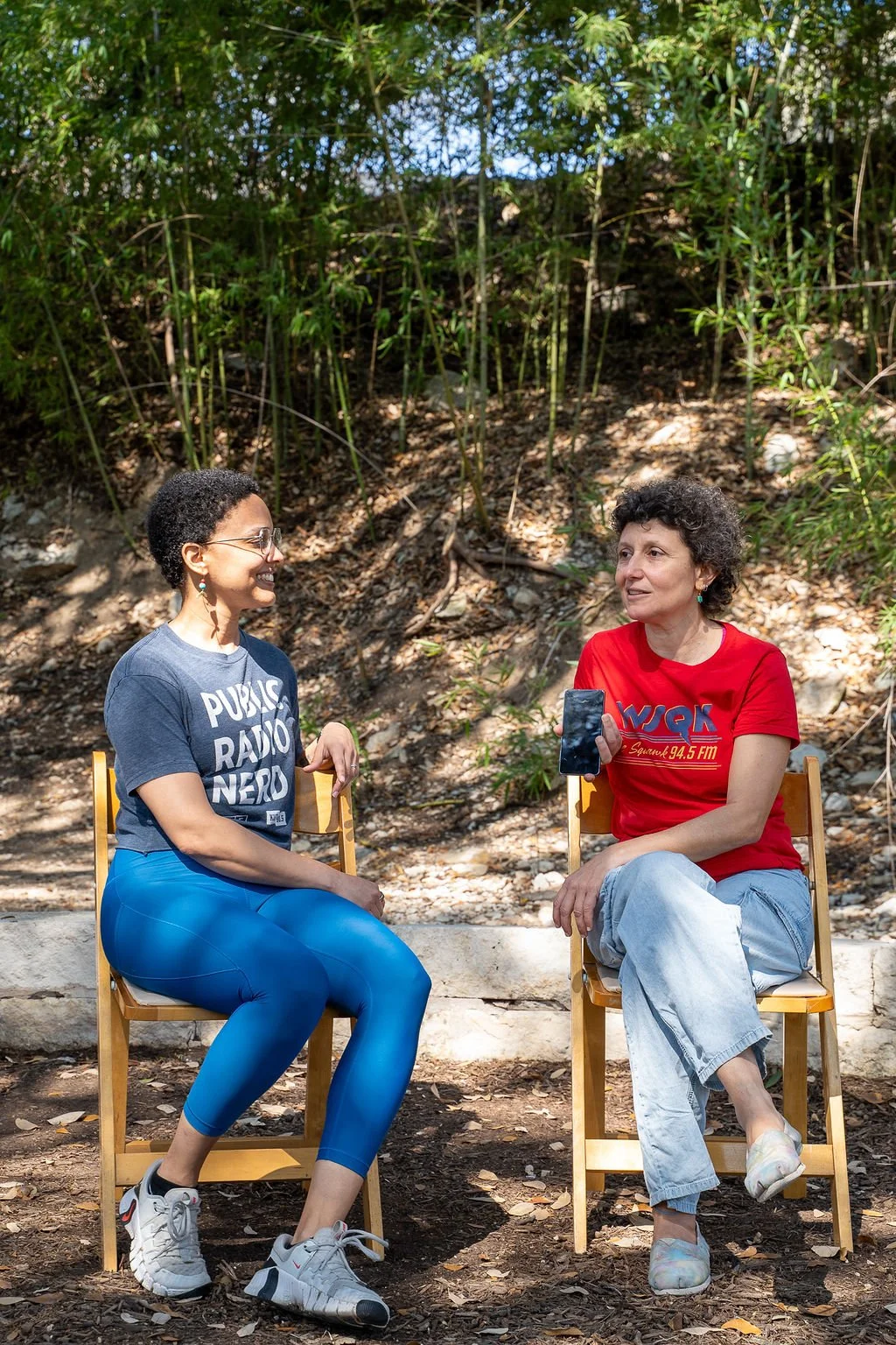 Two retreat attendees talking in chairs outdoors