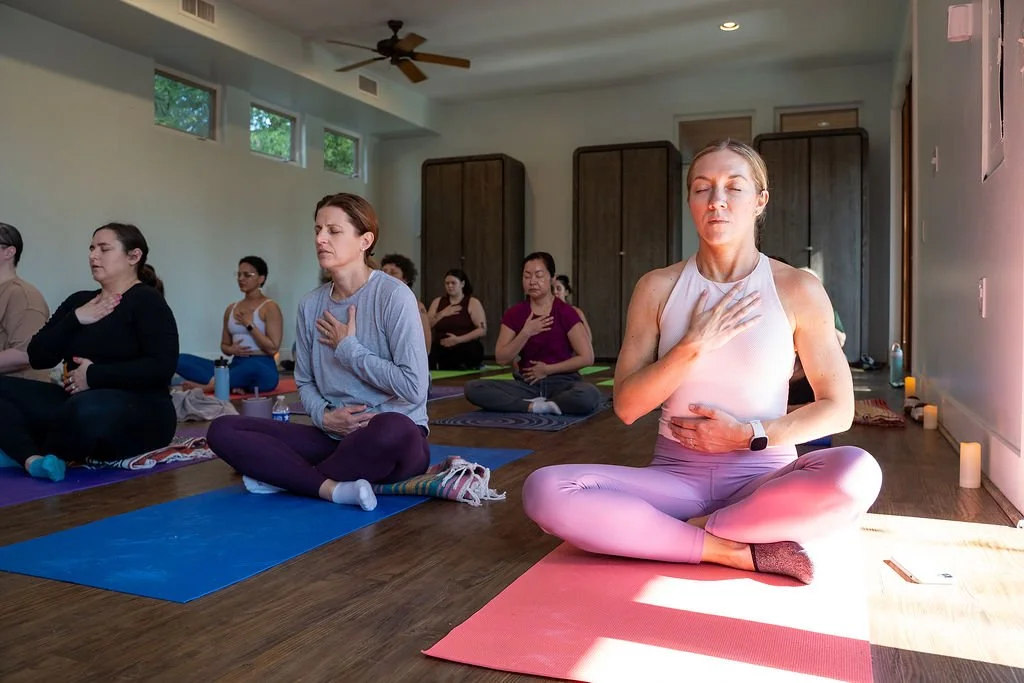 Coach Lisa leading a seated meditation with retreat attendees