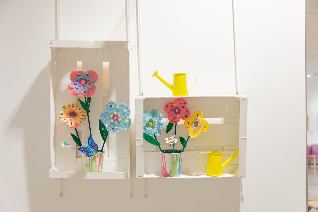 flowers in painted crates on wall