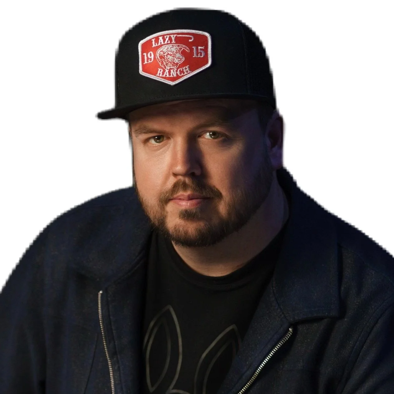 A man with a beard and mustache wearing a black cap with a red patch reading 'Lazy Range 2015' and a black jacket.