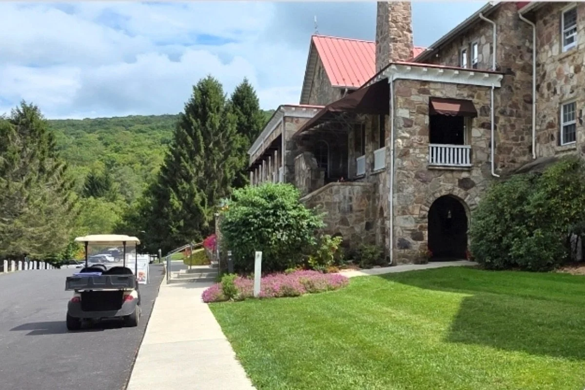 Golf cars lined up in front of Kellerman’s at Mountain Lake Lodge