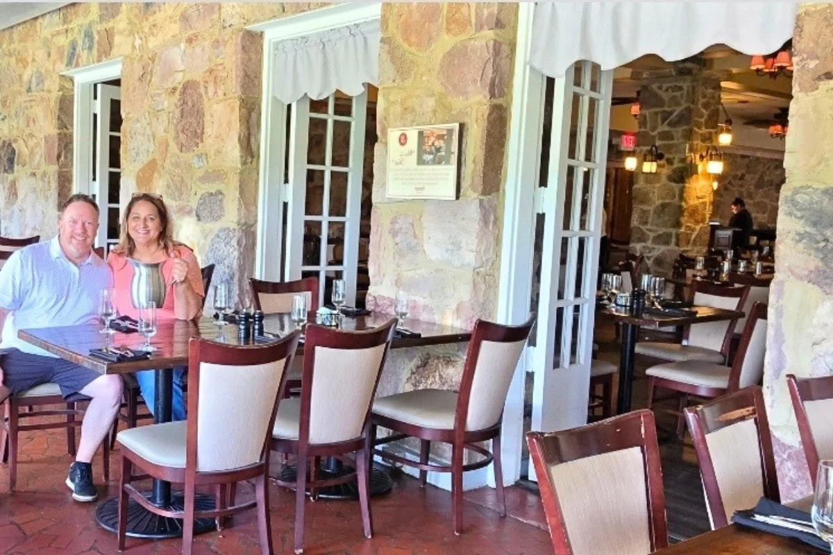 Leigh sitting at a Mountain Lake Lodge dining room table with the pitcher from Dirty Dancing