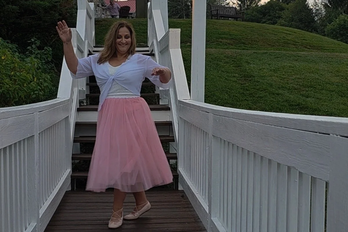 Leigh dancing on a wooden bridge at Mountain Lake Lodge