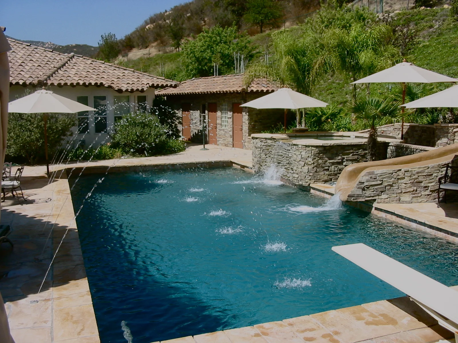 Pool with spa overflow, slide and water features.jpg