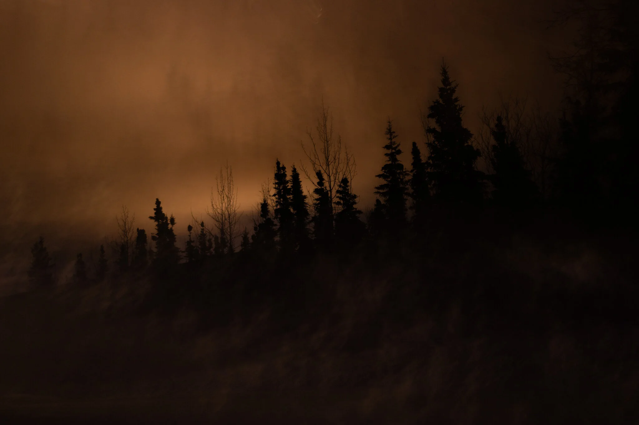 Overcast winter sky glowing from old sodium lights of the lonely city.