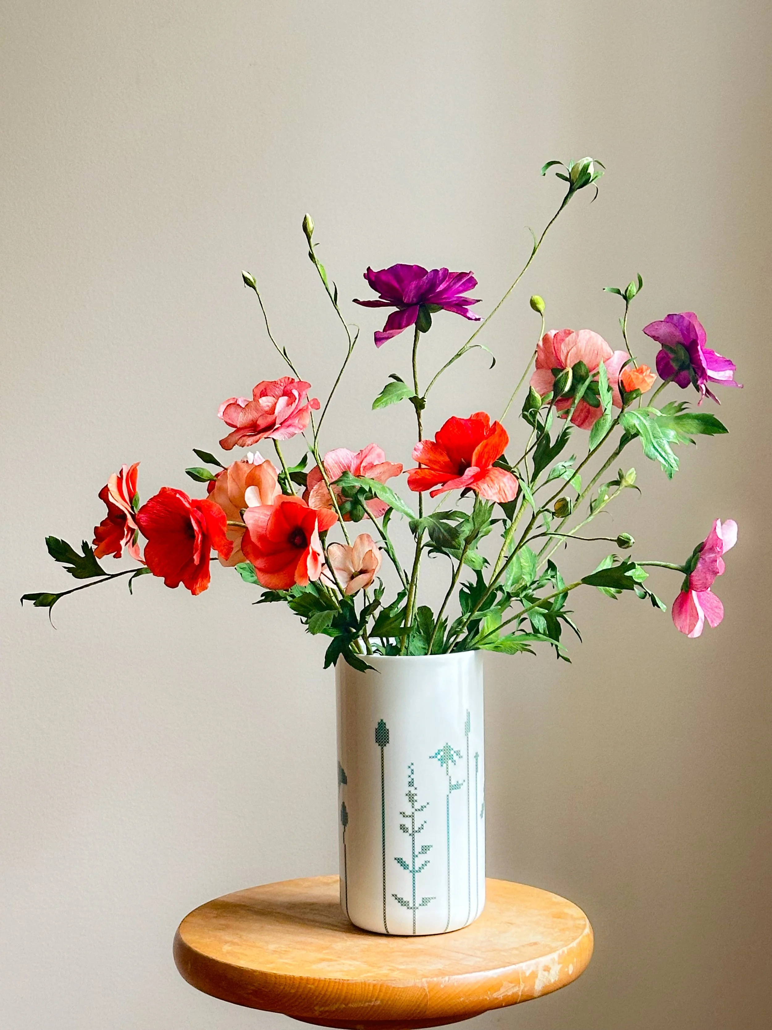 Papirblomster  - sommerfugl ranunkler i en hvid vase