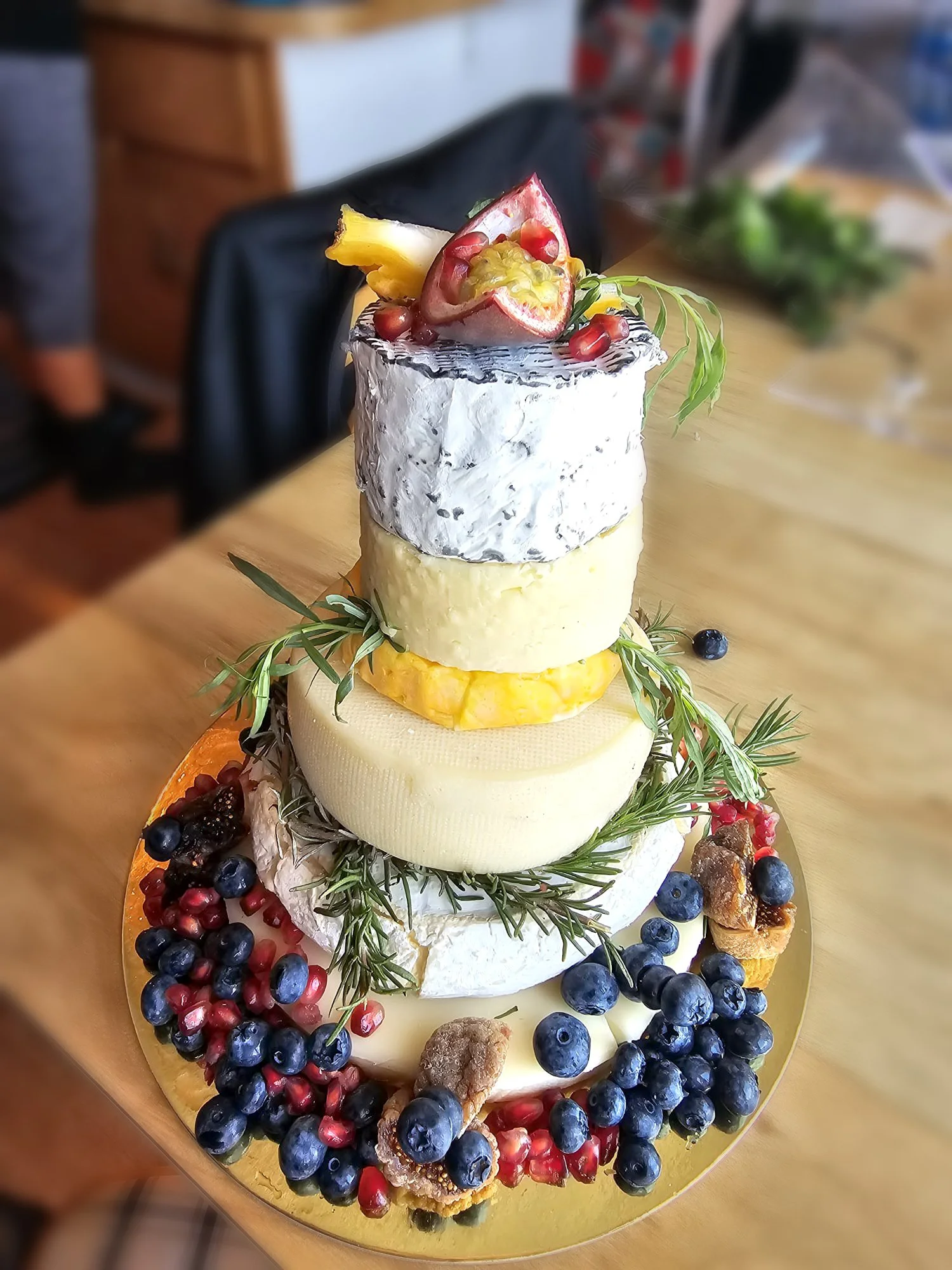 Cheese tower with fresh berries and herbs