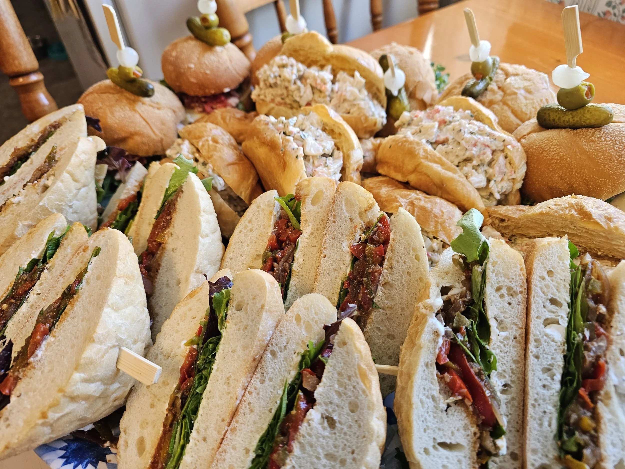Close up of party platter with veggie and seafood salad sandwiches