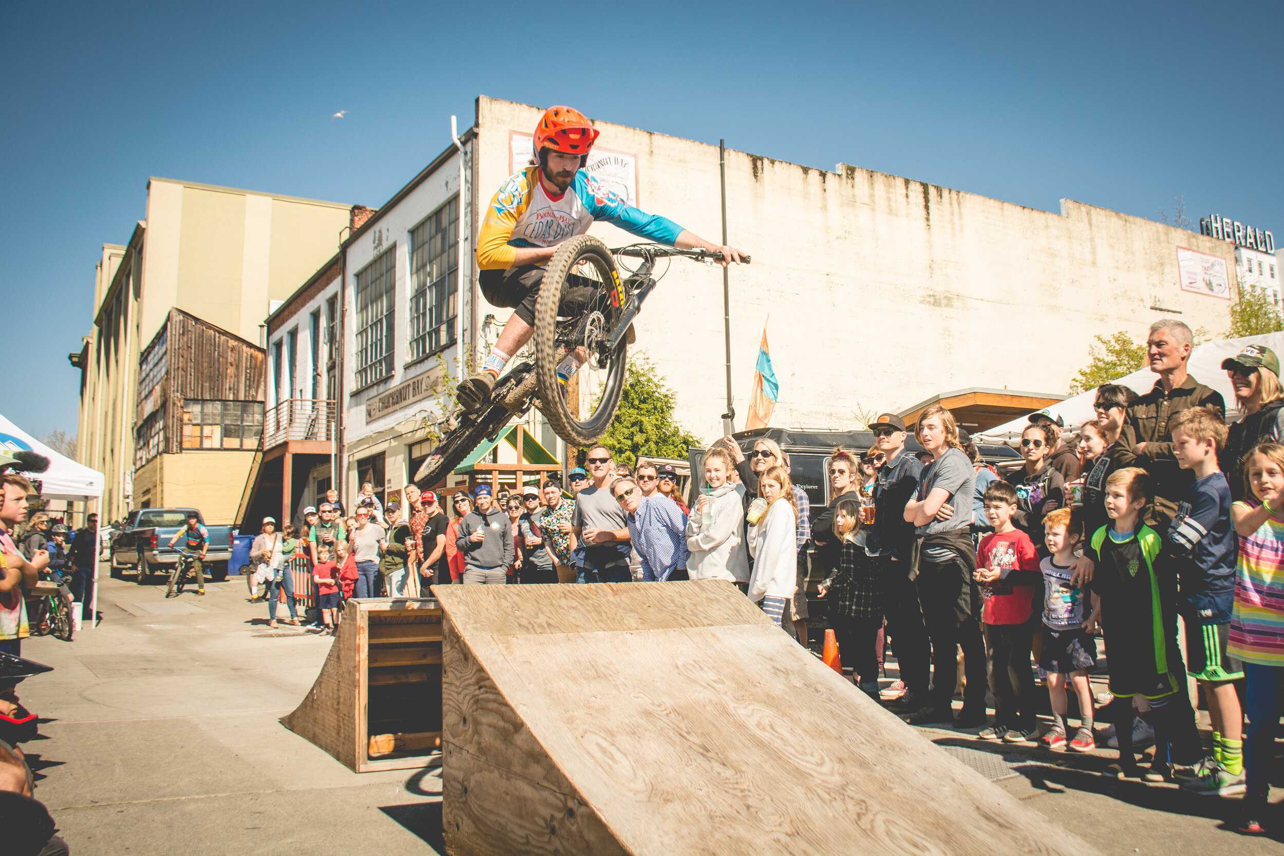 An image of employee Forrest Montgomery executing a jump on his bike at our annual Cedar Dust Alley Event.