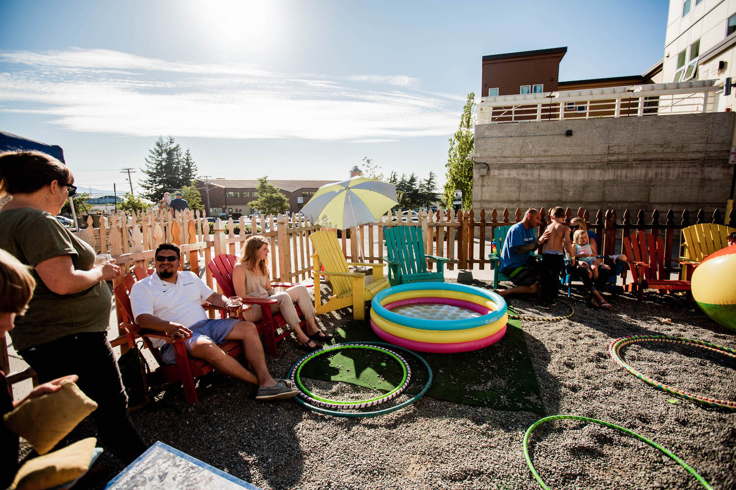 Folks enjoying dipping their toes in kiddie pools on a hot summer day during our Citra Vibes Shindig in the Garden in Summer 2019.