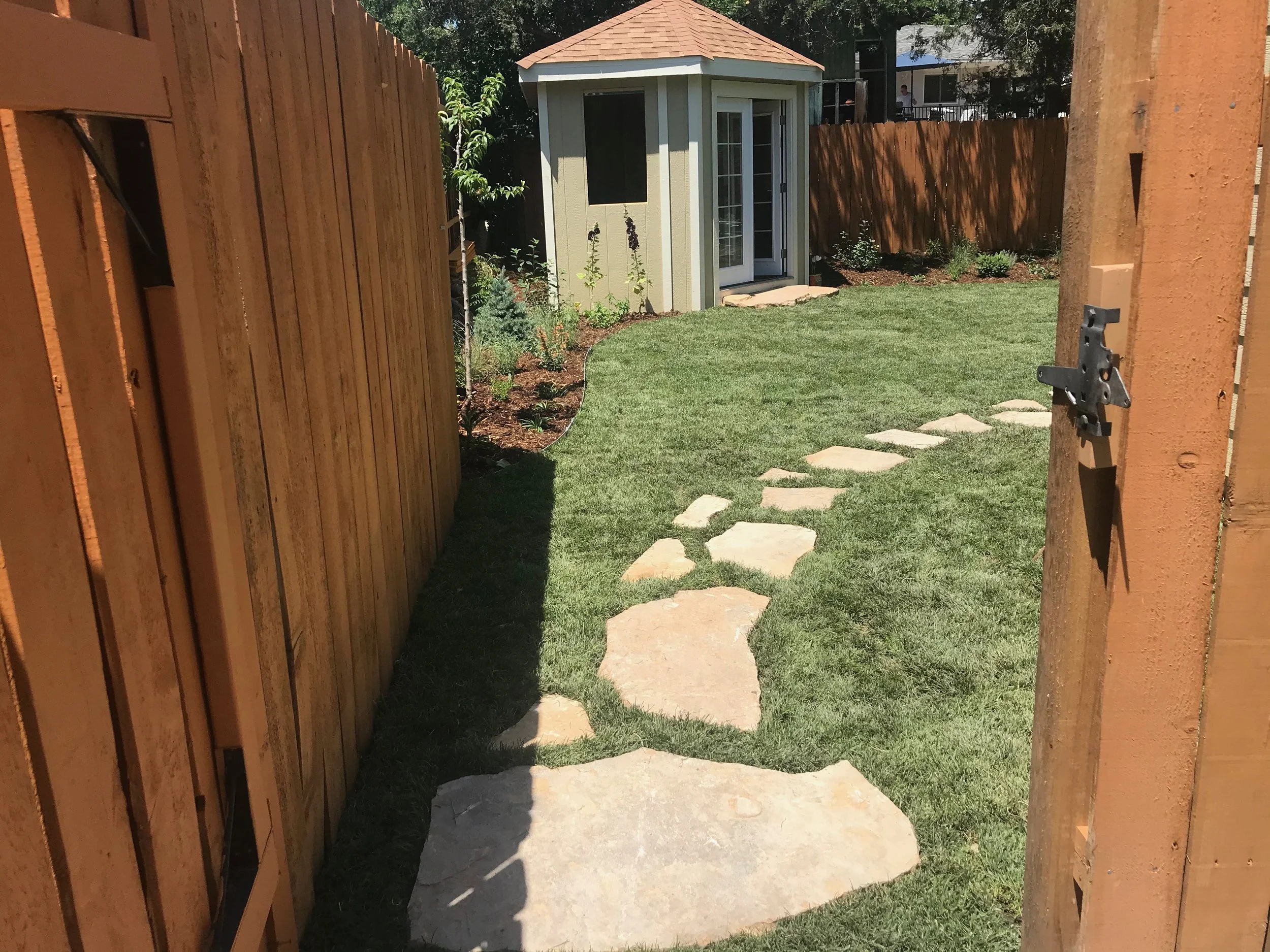 flagstone pathway through grass lawn