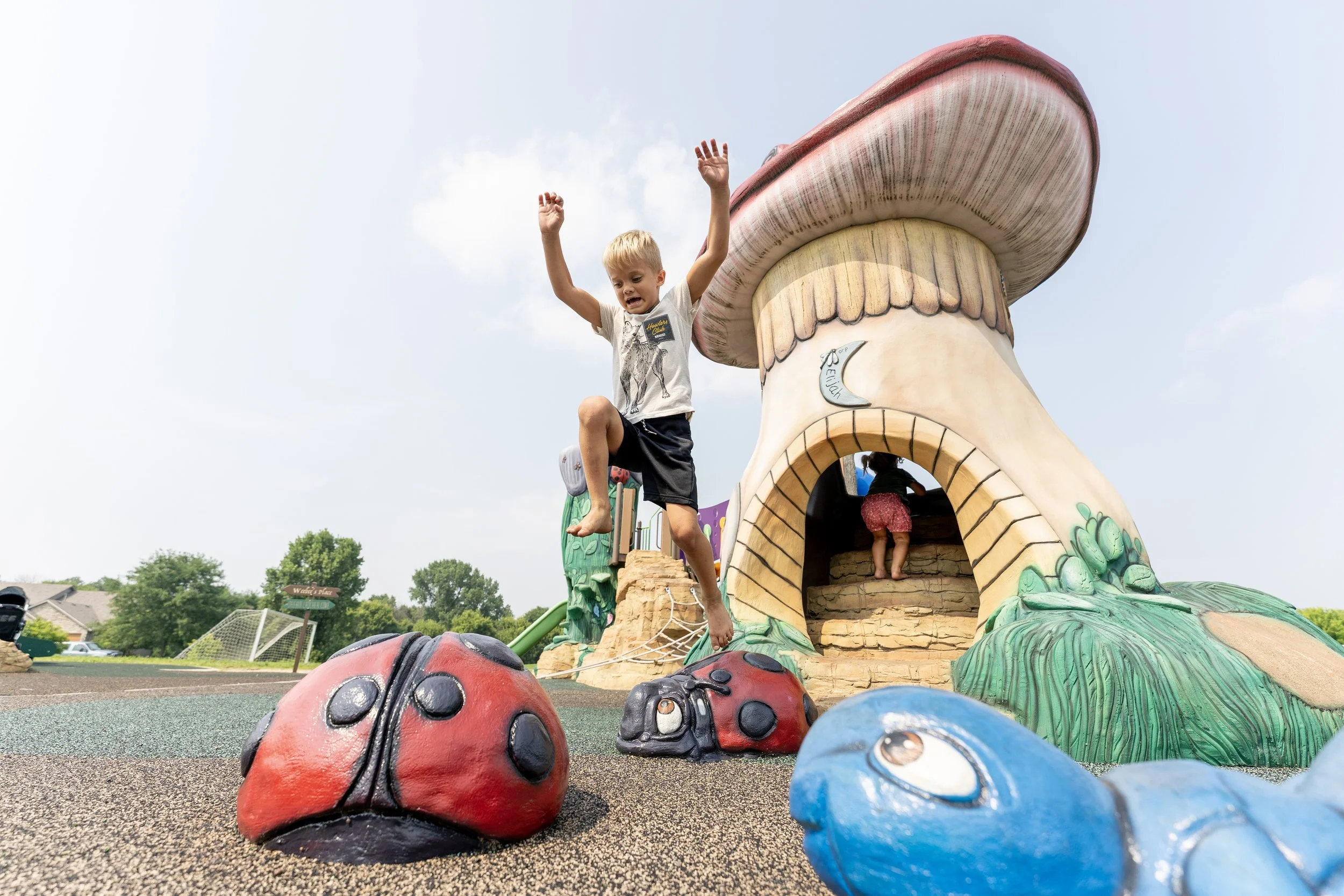39boy jumping on custom concrete climber at a playground.jpg