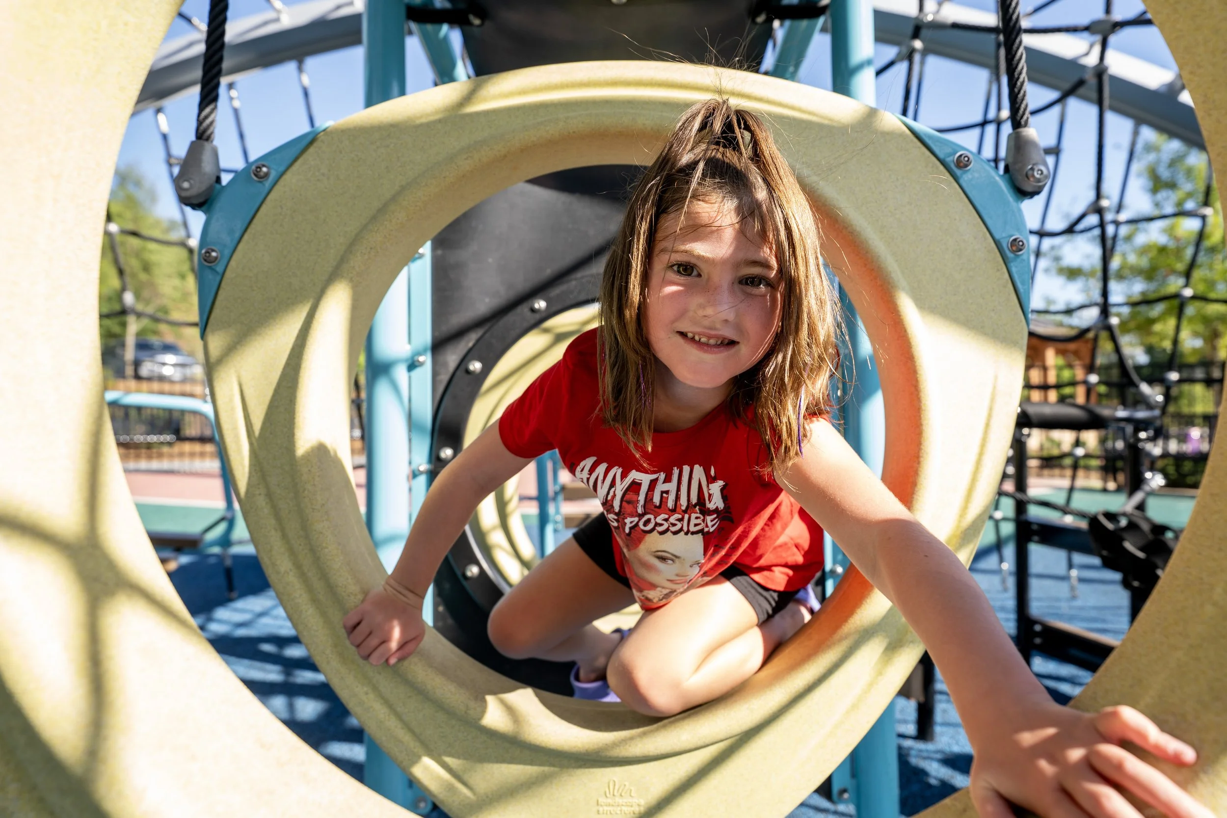 48girl climbing on playground climbers, safety surfacing.jpg