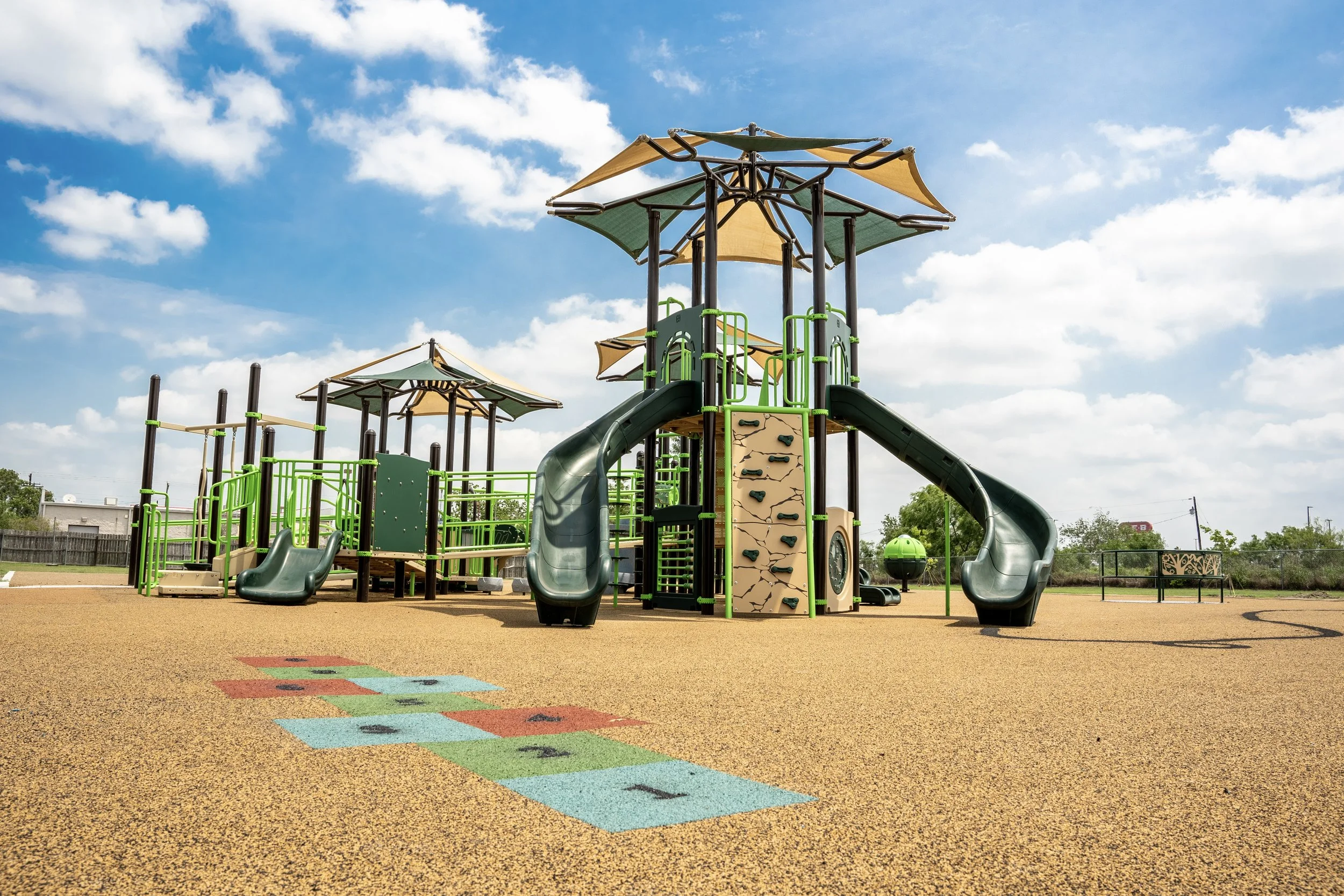 64commerical playground, custom safety surfacing, playground, playground photography, shades, slides.jpg