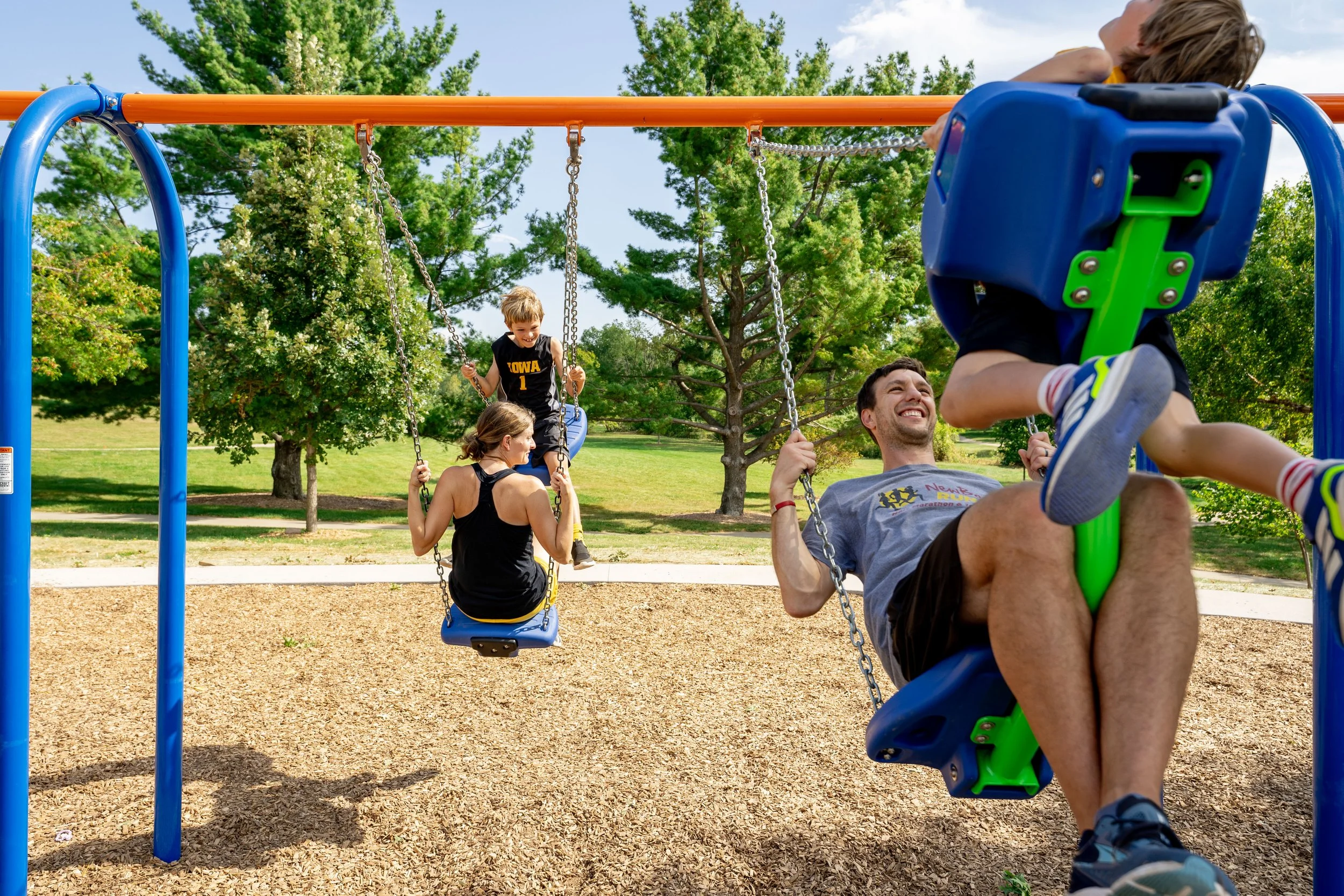 42commercial playground, family swinging on playground, playground mulch, playground photography.jpg