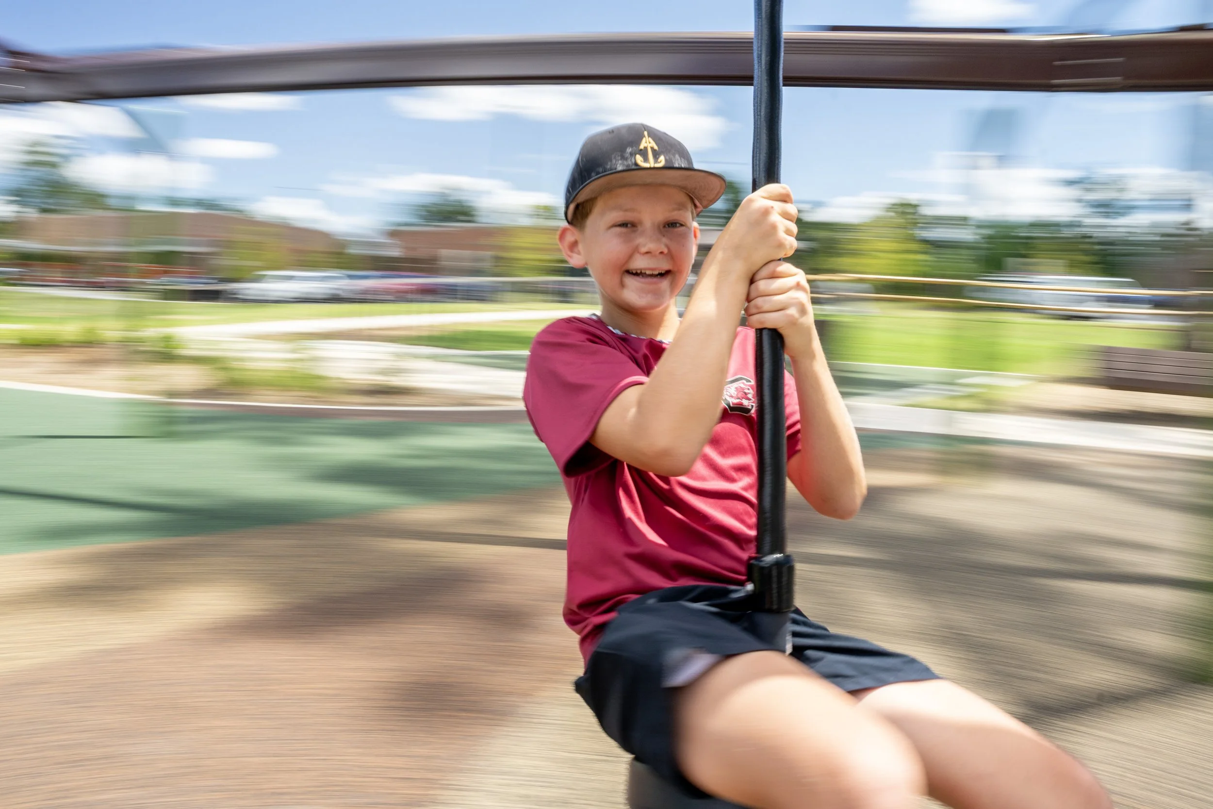 30boy on zipline, commercial playground, playground photography, safety surfacing.jpg