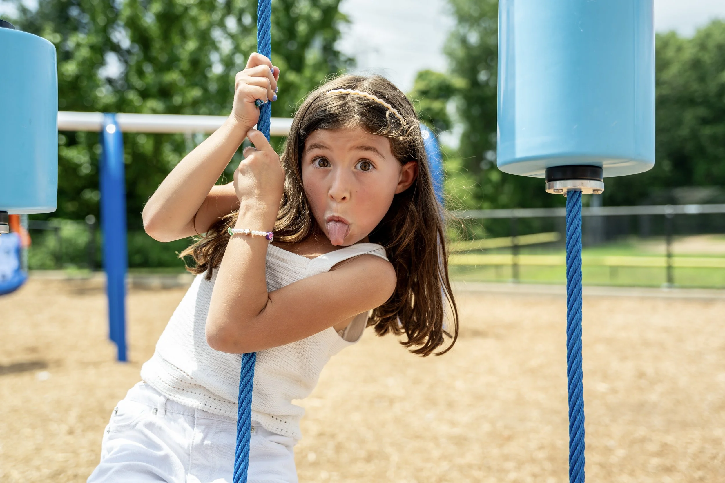 9commercial playground, girl playing on playground, rope climber.jpg