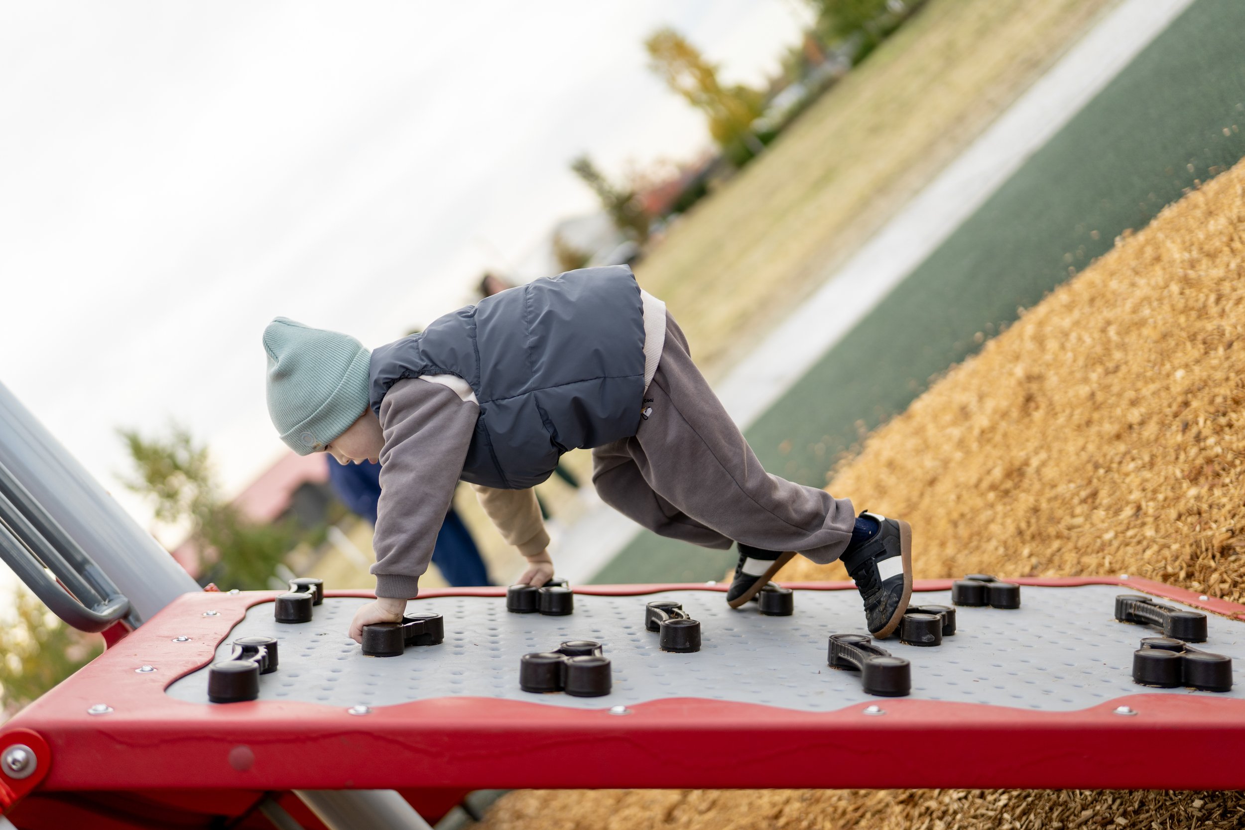 60boy climbing on playground, mulch surfacing, playground, playground photography.jpg