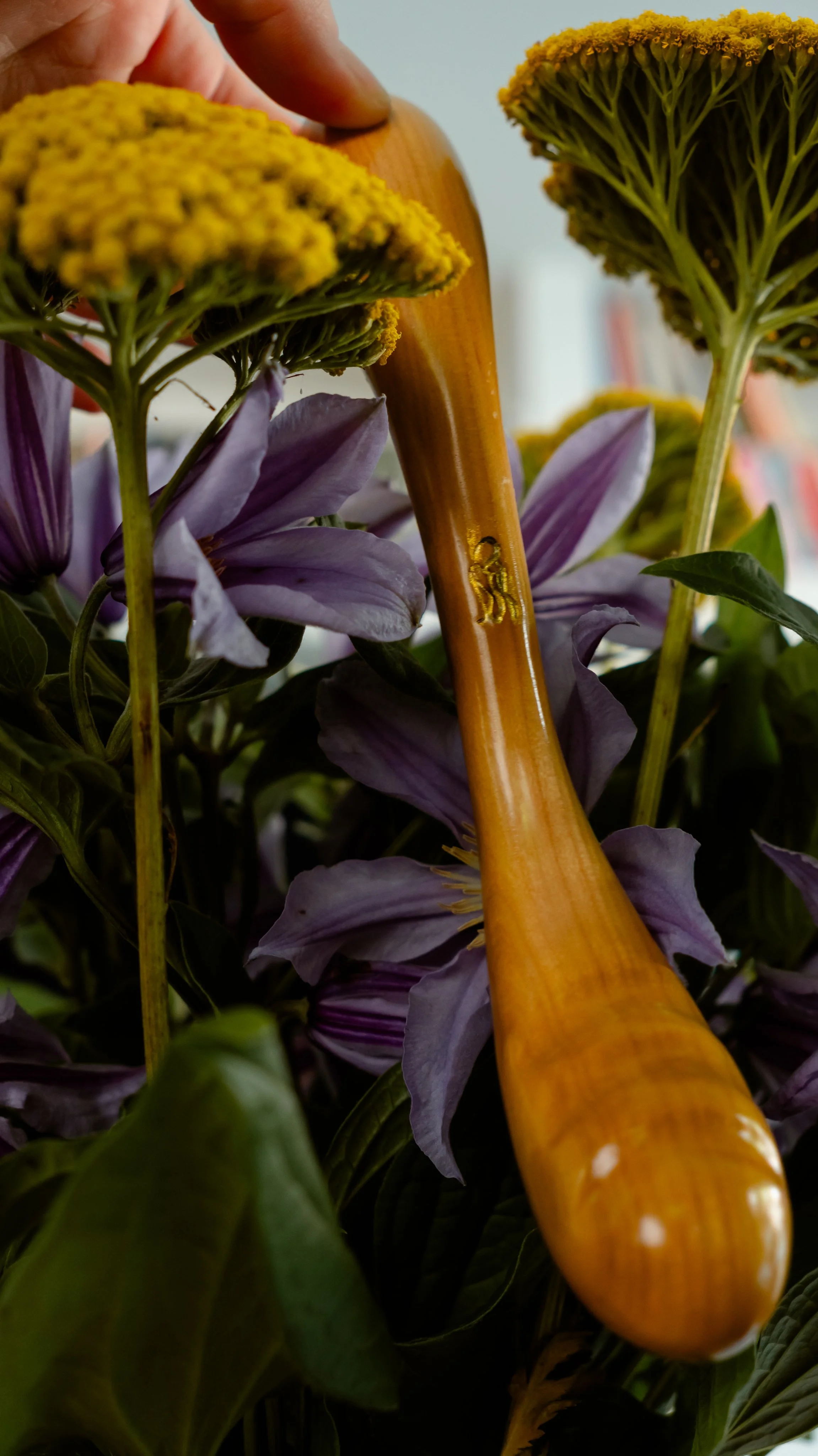 Sensual Desire Twist dildo nestled among flowers.