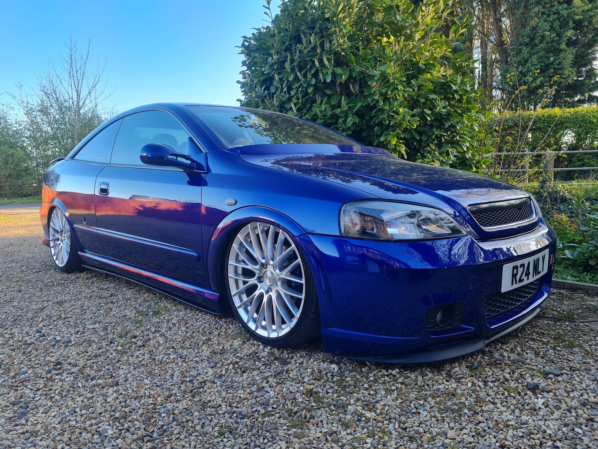 Blue modified Vauxhall Astra 100 edition photo from a low angle.jpg