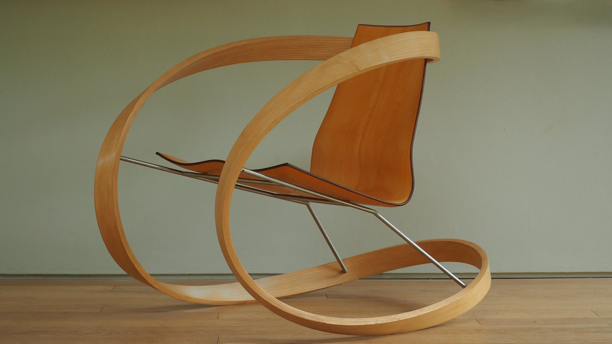 Katie Walker, Ribbon rocking chair, Designed 2006, Made 2018, Ash, brushed stainless steel and natural vegetable tanned saddle leather, 86 x 79 x 113 cm