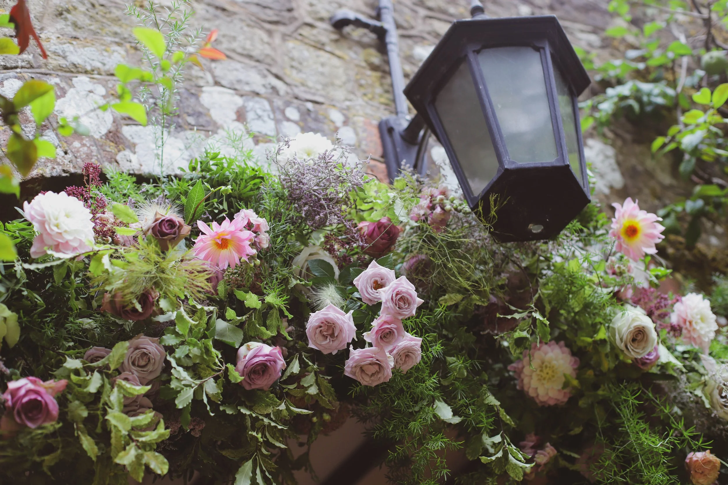 Summer wedding arch arrangement with pink seasonal flowers
